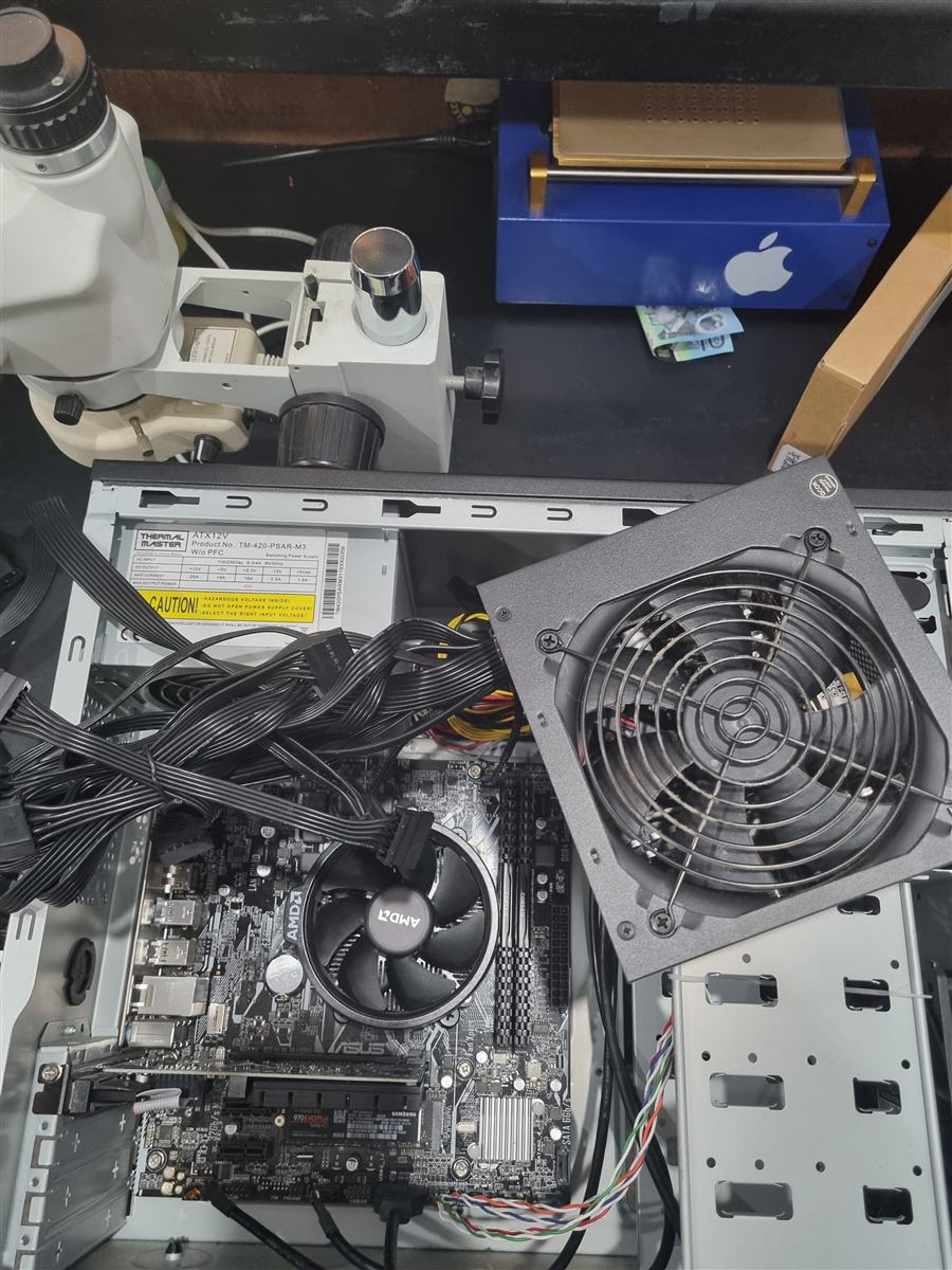 Desktop tower open on the CCFix bench with the power supply unit removed for inspection