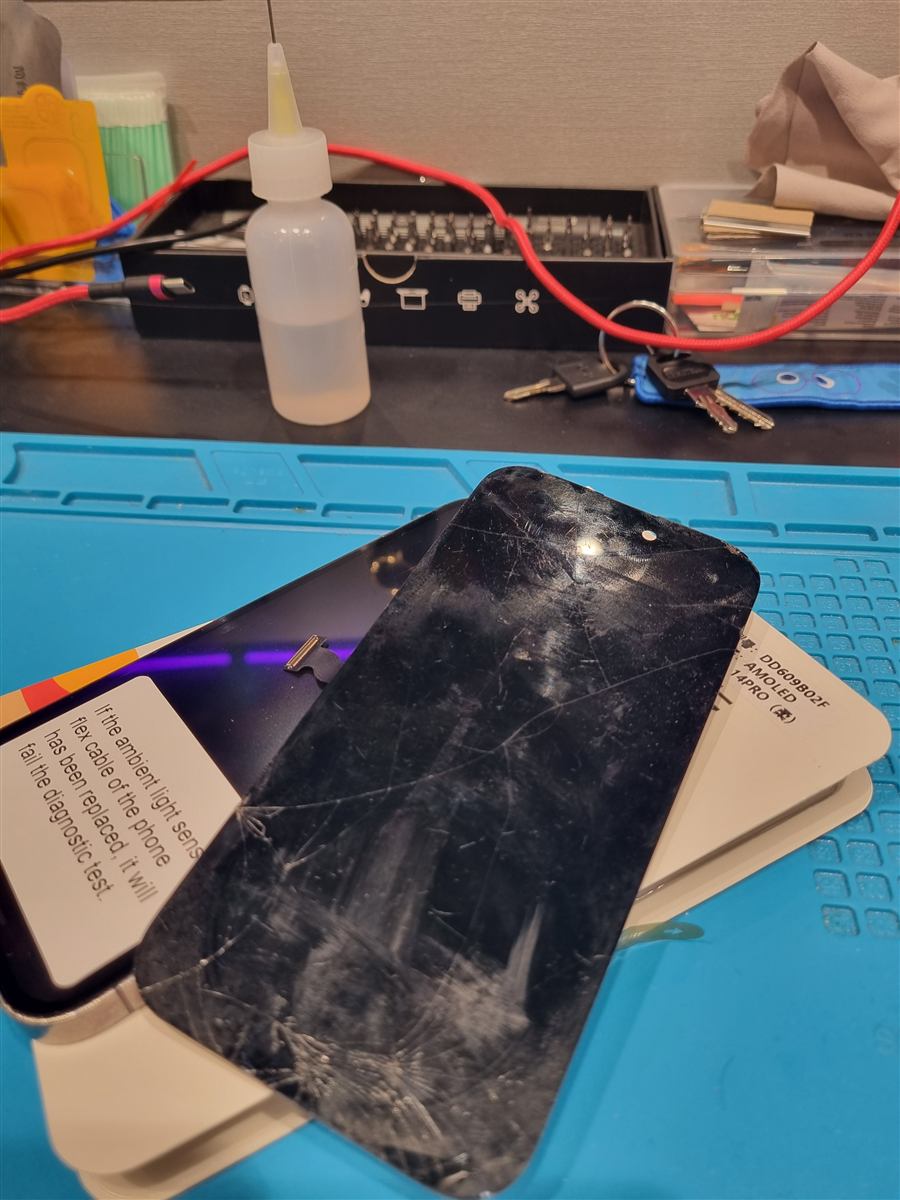 Cracked iPhone 14 Pro screen removed during replacement on the CCFix bench